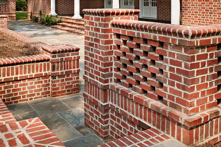 Red brick retaining walls with a decorative pierced pattern enclosing a slate patio in the San Fernando Valley