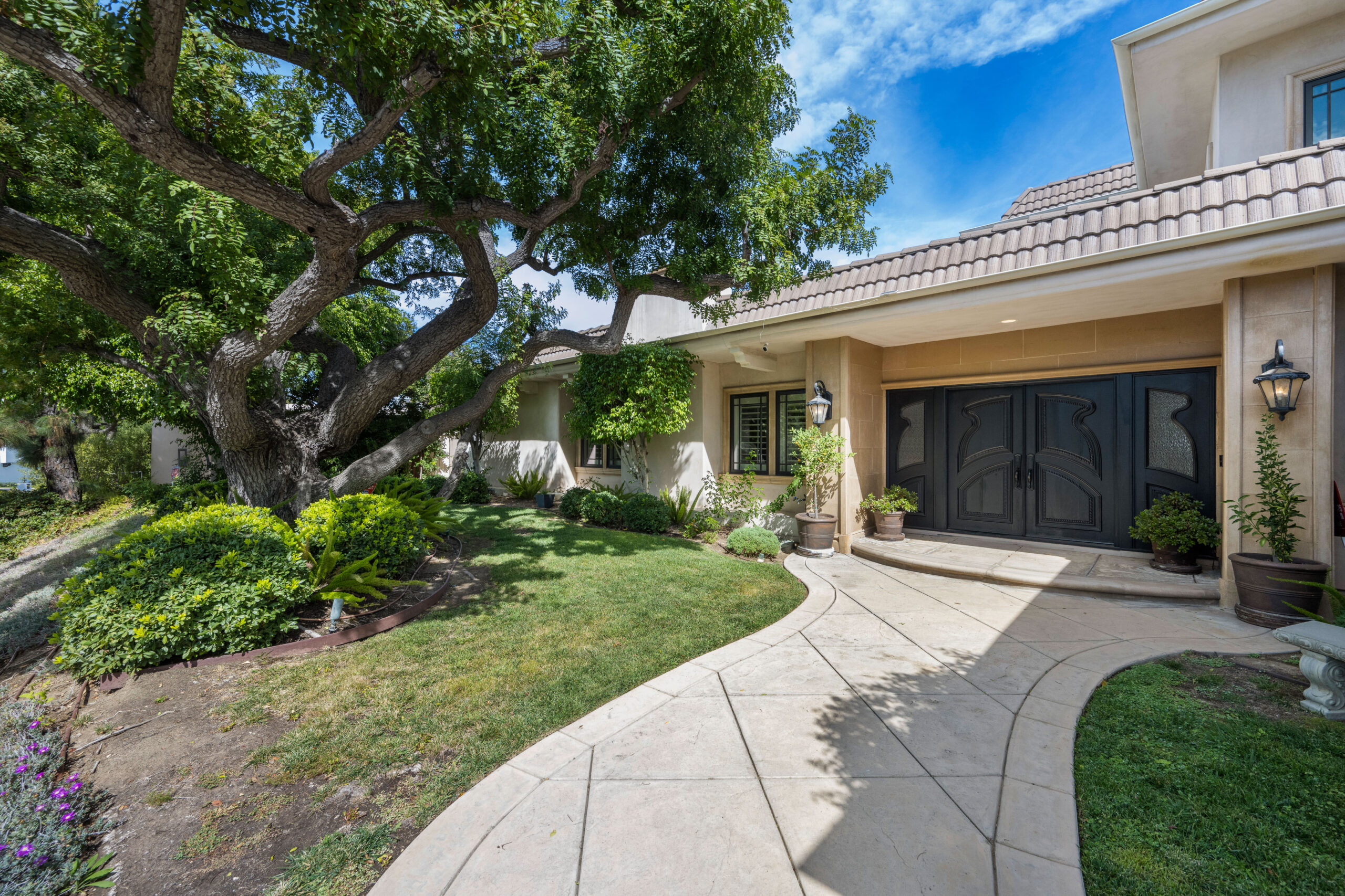 Elegant suburban home with lush water-wise front yard landscaping in Calabasas.