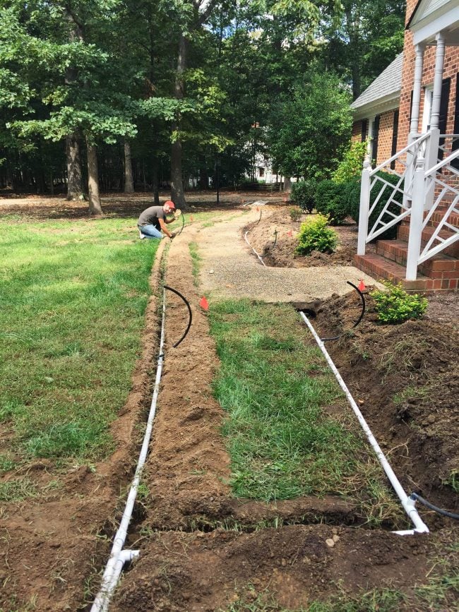 Irrigation pipes laid in open trenches across a front lawn during a front yard landscaping project in the San Fernando Valley