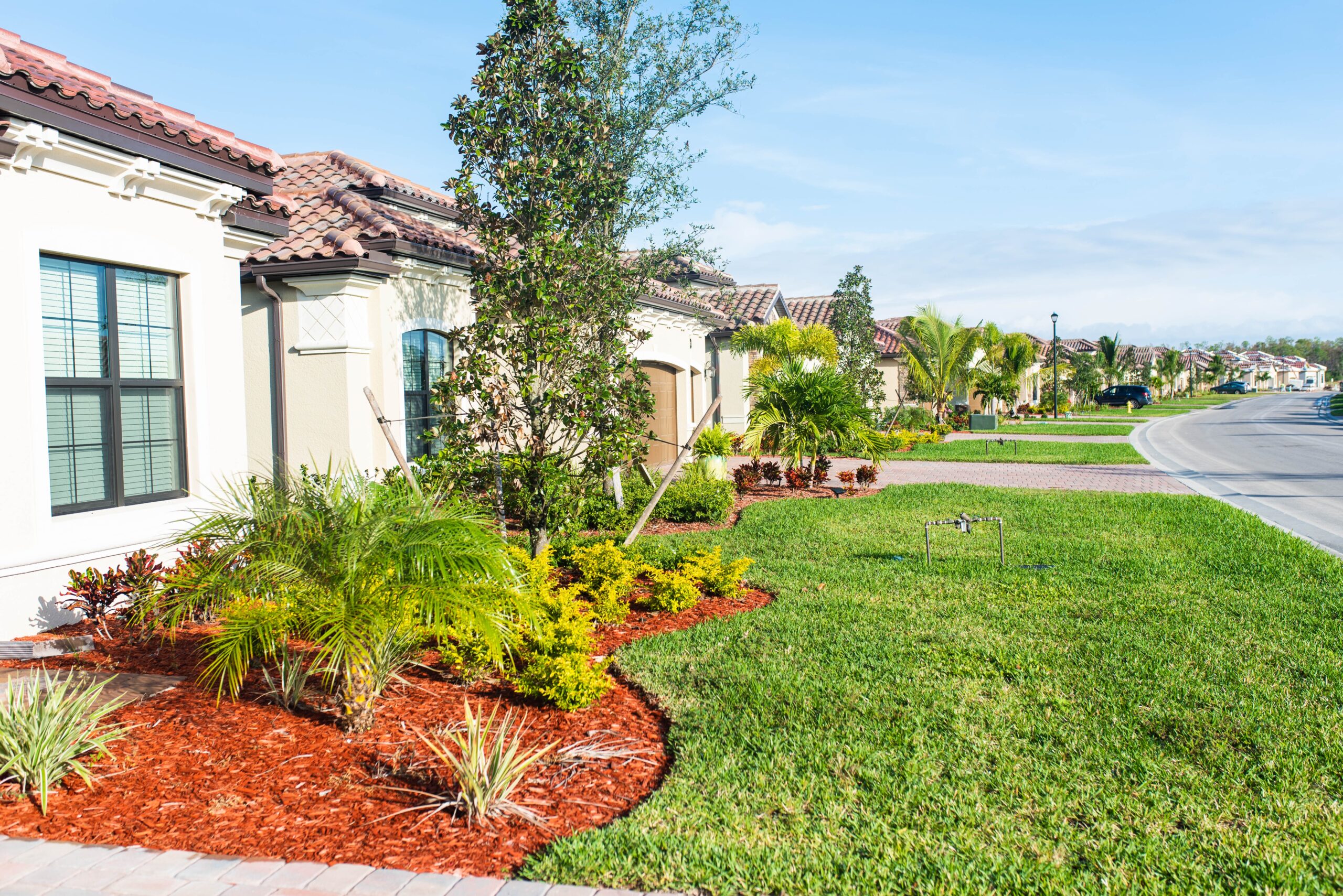 Front yard landscaping with green lawn and flower beds in the San Fernando Valley