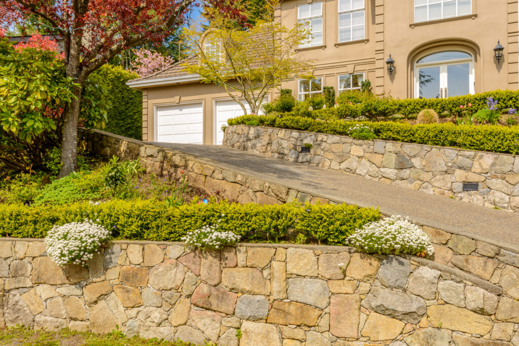 Landscape design with a manicured front lawn, neat shrubs, and a mature tree beside a house in the San Fernando Valley